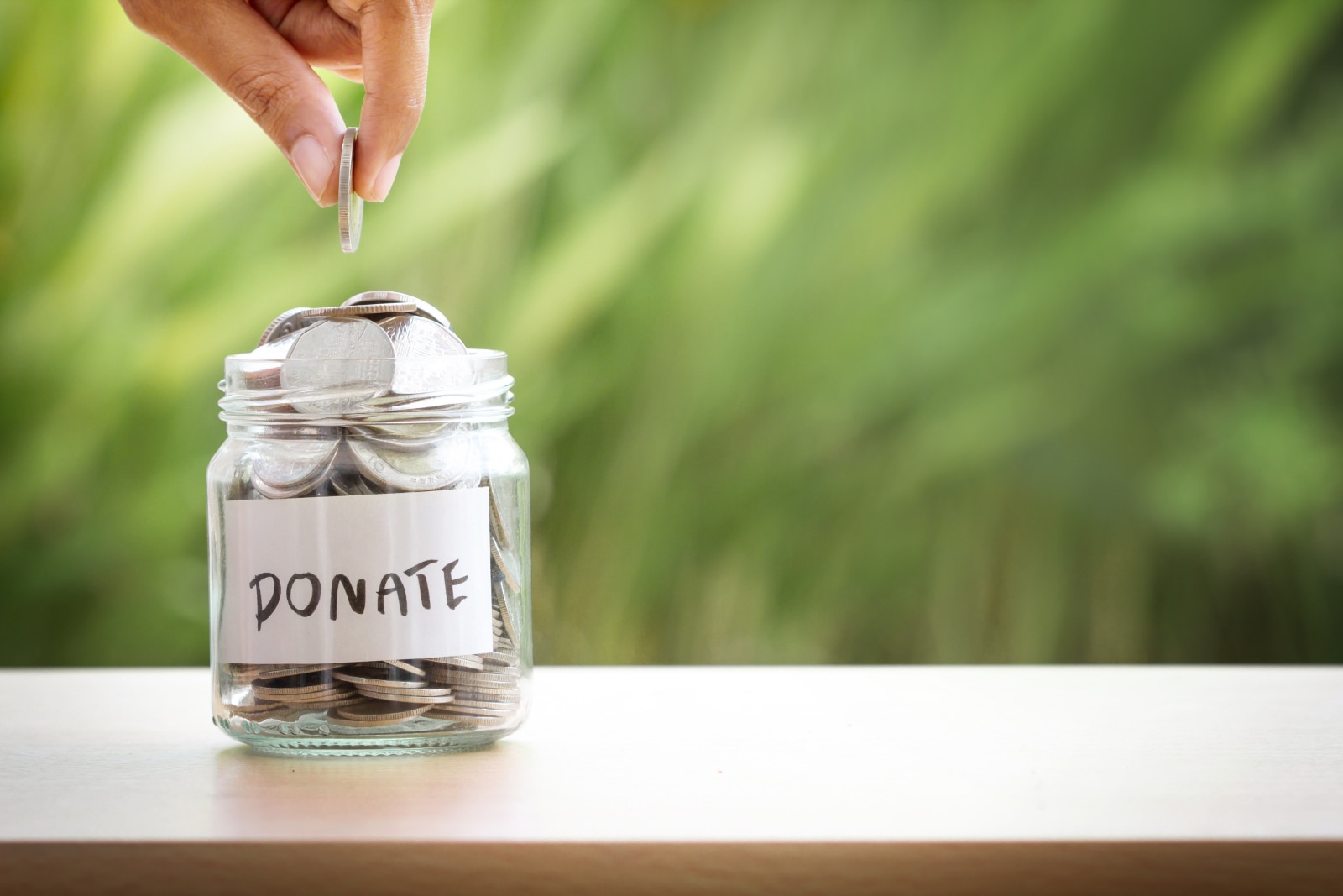 A donation jar full of coins