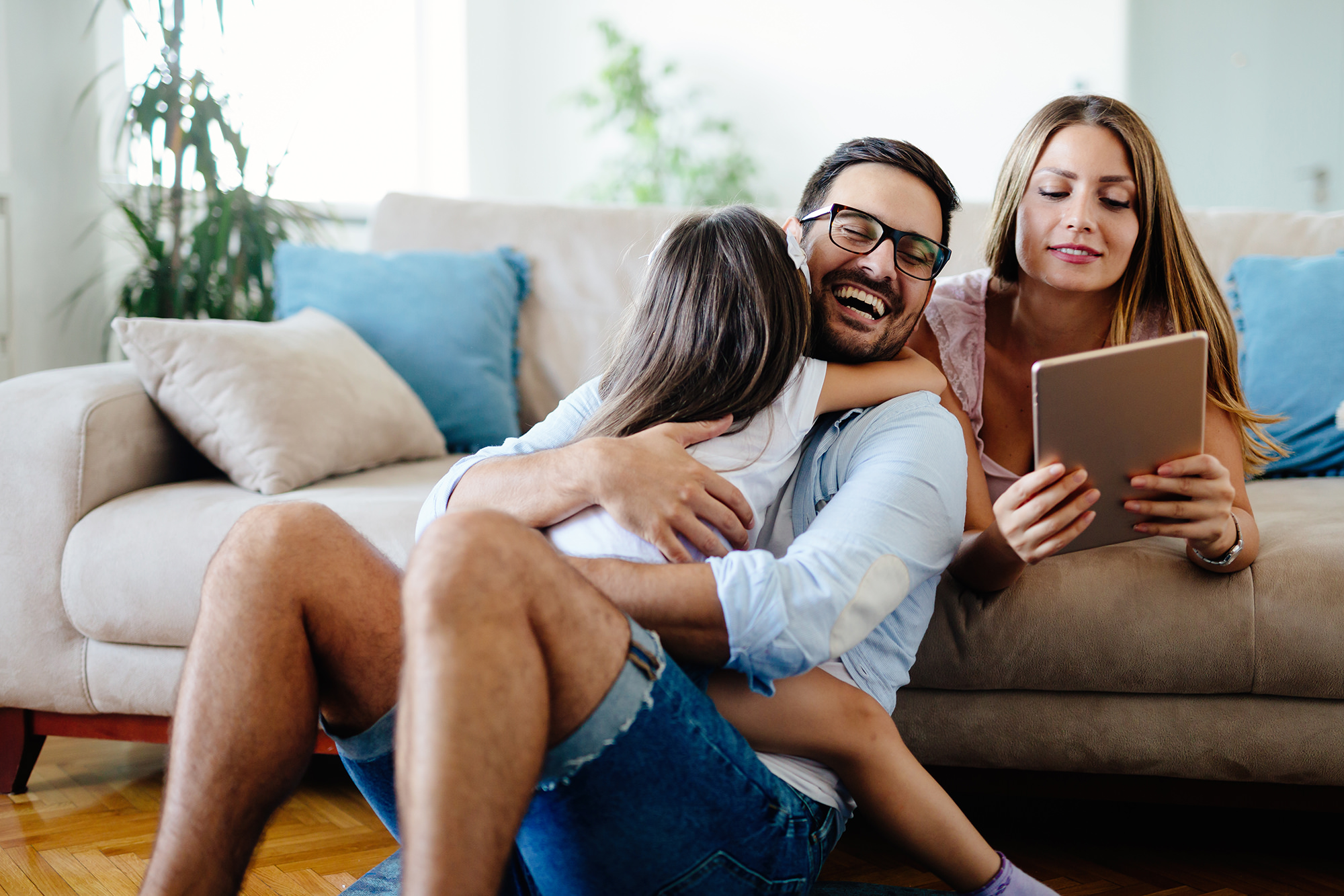 A family in the living room smiling and laughing